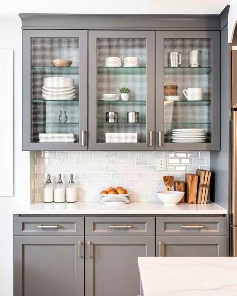 glass fronted cabinetry with metal mesh inserts