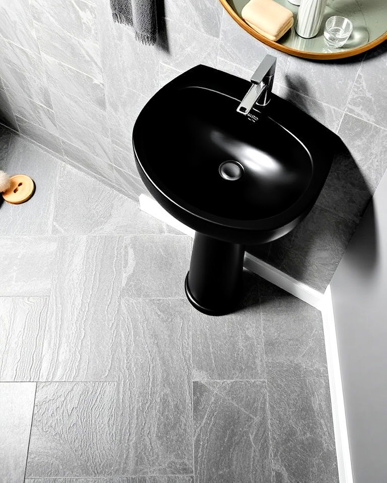 grey slate flooring with black pedestal sink