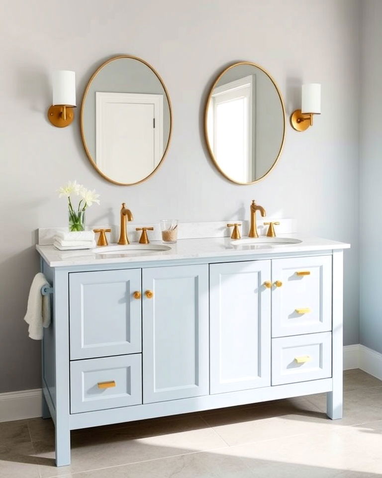 light blue vanity with brass fixtures bathroom