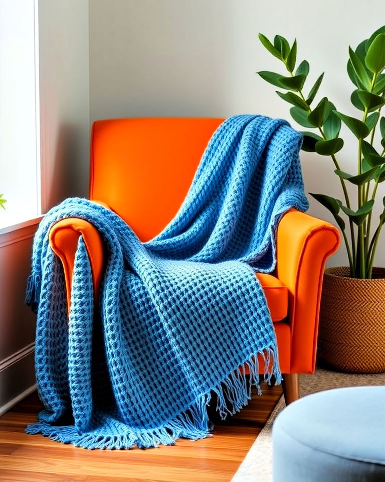 orange armchair with blue throw blanket