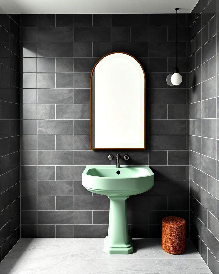 pistachio green sink with dark grey tiles