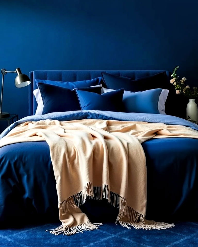 striking monochromatic blue bedding with beige throws