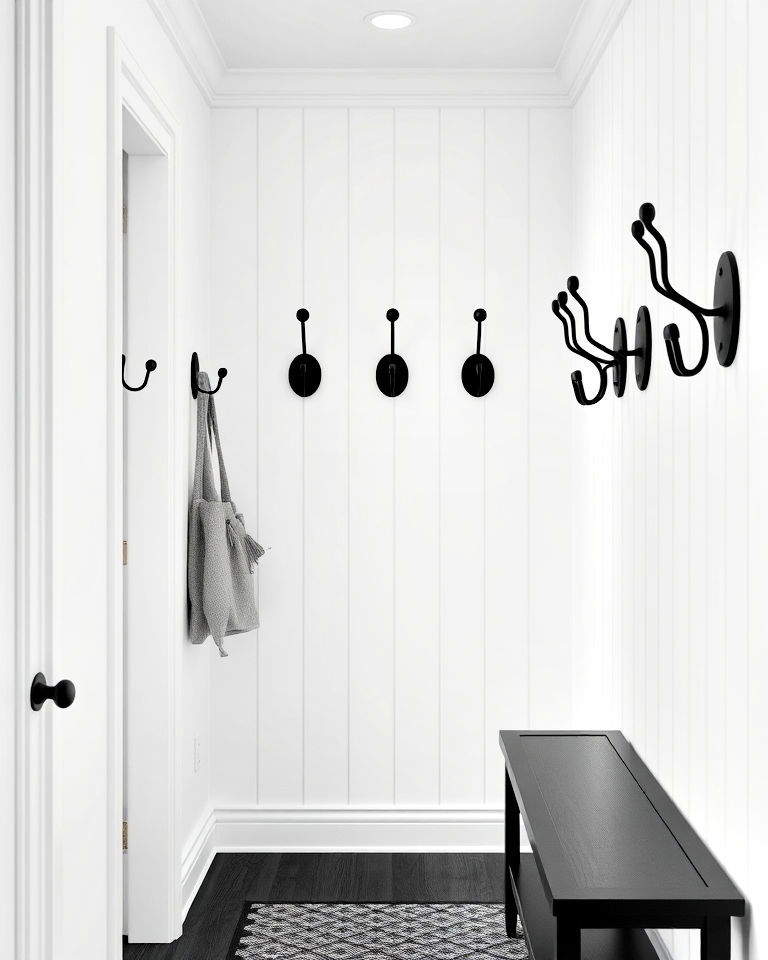 white hallway with black wall hooks